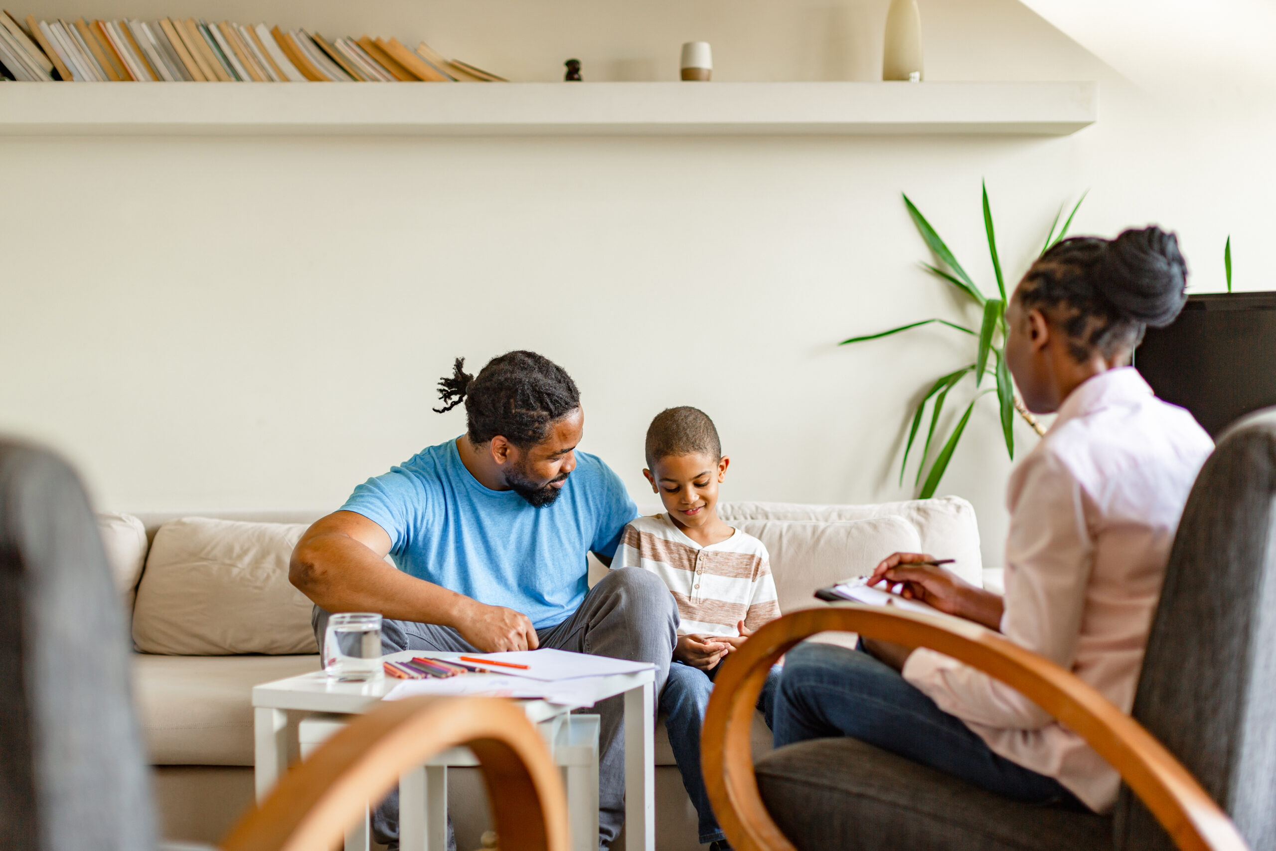 Single father with his son having counseling therapy at home